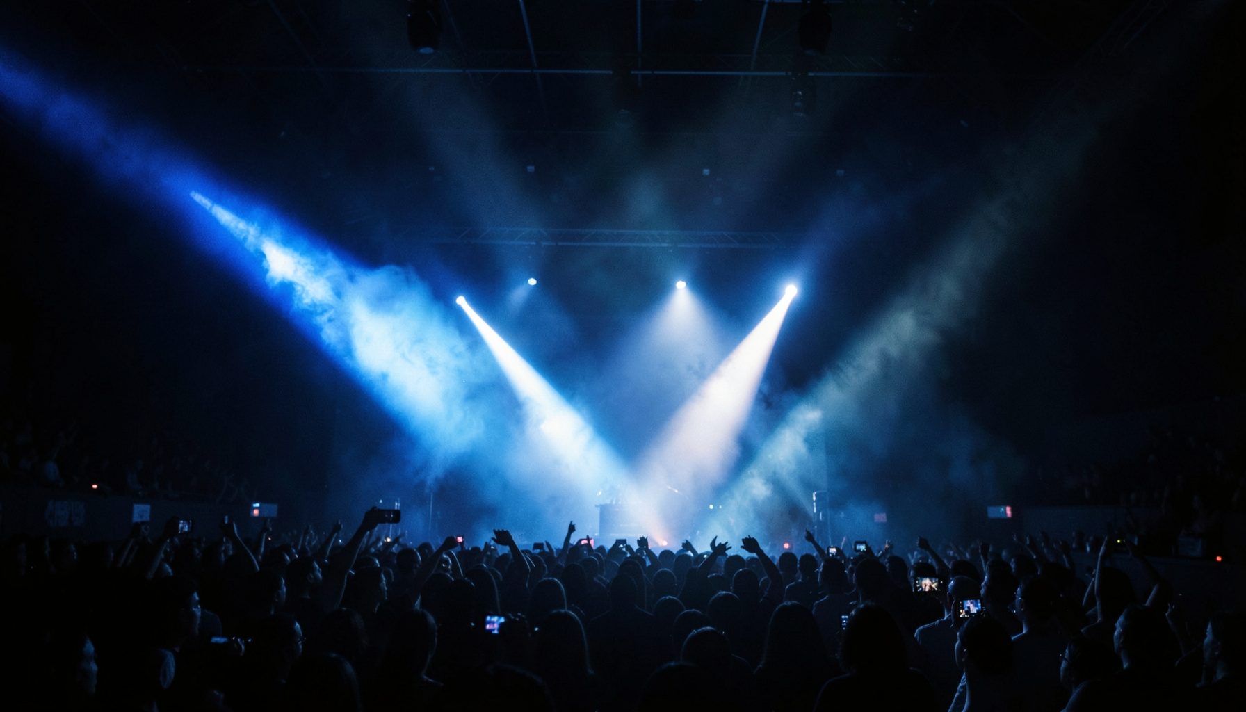 A dark atmospheric stage with dramatic blue and white spotlight beams cutting through haze, evoking the energy of a K-pop performance