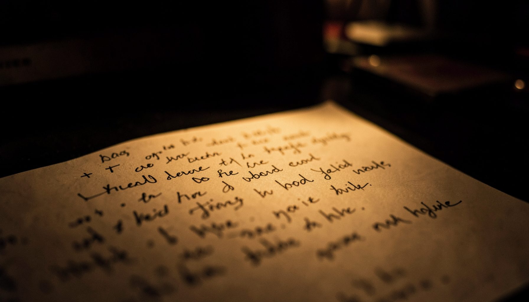 Dark atmospheric close-up under warm amber light, moody and intimate